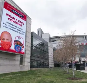  ?? Associated Press ?? An electronic sign encouragin­g fans to wear a mask is seen at Nationals Park, where no baseball will be played this weekend because of a COVID19 outbreak on the Nationals.