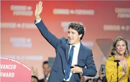  ?? CARLO ALLEGRI/REUTERS ?? Liberal leader and Canadian Prime Minister Justin Trudeau waves beside his wife Sophie Gregoire Trudeau after the federal election at the Palais des Congres in Montreal, Tuesday.