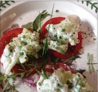  ??  ?? In this twist on a family recipe, cut cucumbers into medium-sized dice before dressing them with crème fraiche and serving them atop sliced tomatoes.