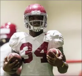  ?? VASHA HUNT — AL.COM VIA AP ?? Alabama running back Damien Harris (34) works through drills during football practice, Wednesday at the Hank Crisp Indoor Facility in Tuscaloosa, Ala.