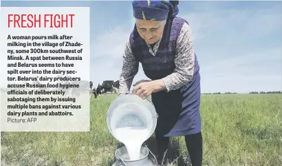 ?? Picture: AFP ?? A woman pours milk after milking in the village of Zhadeny, some 300km southwest of Minsk. A spat between Russia and Belarus seems to have spilt over into the dairy sector. Belarus’ dairy producers accuse Russian food hygiene officials of deliberate­ly...