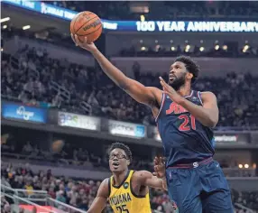  ?? AP ?? The 76ers’ Joel Embiid puts up a shot against the Pacers’ Jalen Smith during the first half on Tuesday in Indianapol­is.