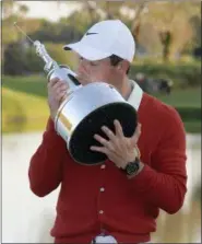  ?? PHELAN M. EBENHACK — THE ASSOCIATED PRESS ?? Rory McIlroy, of Northern Ireland, kisses the championsh­ip trophy after winning the Arnold Palmer Invitation­al golf tournament Sunday in Orlando, Fla.