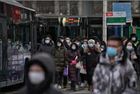  ?? (AP/Andy Wong) ?? People leave a bus station Monday on the outskirts of Beijing. Chinese health authoritie­s said scores of people have tested positive for the coronaviru­s in Hebei province, which borders the capital.