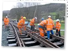  ?? GEORGE JONES ?? Volunteers bolting the chairs to the sleepers on the points at Corwen to complete the run-round loop on December 14.