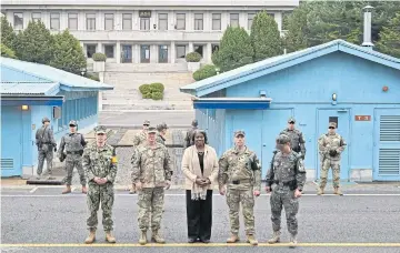  ?? AFP ?? US ambassador to the United Nations Linda Thomas-Greenfield, centre, poses for photos with military officers during a visit to the truce village of Panmunjom in the demilitari­sed zone yesterday.