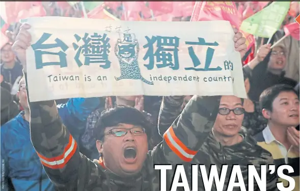  ??  ?? A supporter of President Tsai Ing-wen holds a banner during a rally outside the Democratic Progressiv­e Party (DPP) headquarte­rs in Taipei during the celebratio­n of her election victory on Jan 11.