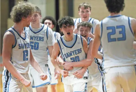  ?? PHOTOS BY PATRICK OEHLER/POUGHKEEPS­IE JOURNAL ?? The Saugerties boys basketball team celebrate their 46-45 victory over Byram Hills in the New York State sub-regional game in Poughkeeps­ie on Monday.