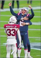 ?? ELISE AMENDOLA/AP PHOTO ?? New England Patriots kicker Nick Folk celebrates his game-winning field goal as time expires in Sunday’s game against the Arizona Cardinals in Foxborough, Mass.