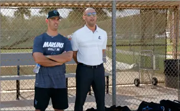  ??  ?? Miami Marlins Special advisor to baseball operations Jorge Posada (left) and Marlins Chief Executive Officer Derek Jeter talk during a workout at the team’s spring training baseball facility in Jupiter, Fla., on Monday.DaVID SanTIago/MIaMI HeralD VIa aP