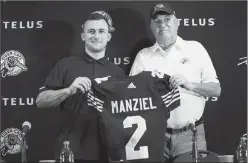  ?? Canadian Press photo ?? Former NFL quarterbac­k and Heisman Trophy winner Johnny Manziel, left, holds a jersey with Hamilton Tiger-Cats head coach June Jones after announcing that he has signed a two-year contract to play in the CFL for the Tiger-Cats at a press conference in...