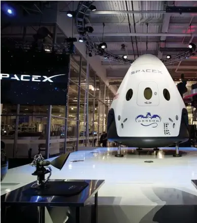  ??  ?? In 2014, SpaceX unveiled a version of its Dragon spacecraft that would accommodat­e a crew. The uppstart company has received strategic support from NASA.