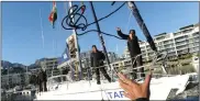  ??  ?? LANDFALL: March 14. Crew toss down ropes to dock in Cape Town until