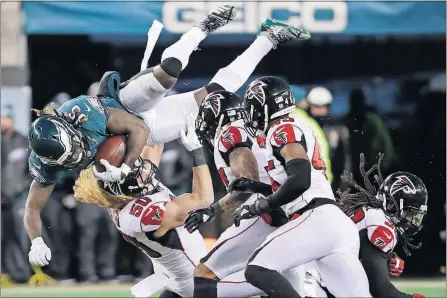  ?? [CHRIS SZAGOLA/THE ASSOCIATED PRESS] ?? Eagles running back Jay Ajayi is brought down by Falcons linebacker Brooks Reed during a first-half carry.