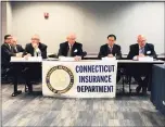  ?? CTMirror.org ?? Insurance officials attend a public hearing on proposed rate hikes in 2019.