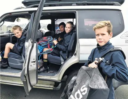  ?? PHOTO: PETER MCINTOSH ?? All aboard . . . Tahuna Intermedia­te pupils (from left) Tristan Graham (11), William Mooney (12), Hugh Jack (11) and James Cameron (11) carpool home to the Otago Peninsula after school yesterday.