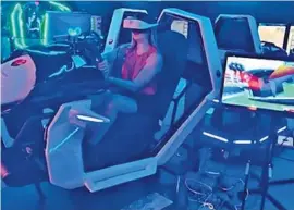  ?? VR PARK/COURTESY ?? A guest uses a virtual-reality simulator at VR Park, a 14,000-square-foot arcade in North Miami that opened to the public in late March.