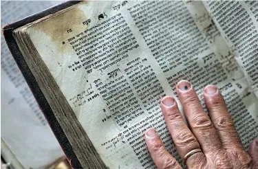  ??  ?? OLD SCHOOL TEXTING: Matt’s personal copy of the original Zohar bears the marks of his two decades of labor translatin­g the text to English..