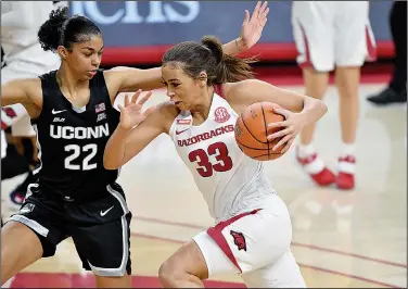  ?? Associated Press ?? Lets dance: Arkansas guard Chelsea Dungee (33) tries to drive past Connecticu­t defender Evina Westbrook. Led by the SEC scoring leader, the Razorbacks (19-8) are in their first NCAA Tournament since 2015.