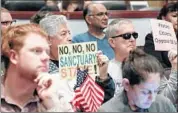  ?? Irfan Khan Los Angeles Times ?? RESIDENTS oppose the state’s so-called sanctuary law, signed by Gov. Jerry Brown last year, at an Orange County Board of Supervisor­s meeting Tuesday.