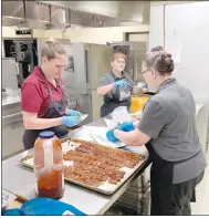  ?? (Special to NWA Democrat-Gazette/Maylon T. Rice) ?? Lincoln Middle School dietary staff members Jennifer Gates (from left), Tammy Wilson and Lorene Jewett prepare lunch for the district’s students recently at the school.