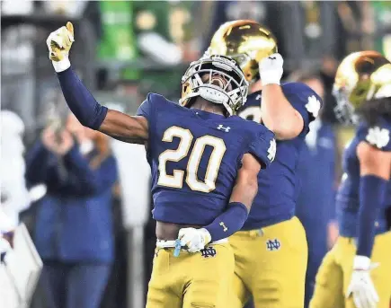  ?? MATT CASHORE/USA TODAY SPORTS ?? Notre Dame cornerback Benjamin Morrison celebrates after an intercepti­on during a 2023 game against the USC Trojans at Notre Dame Stadium.