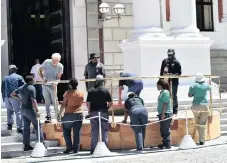  ?? | JAIRUS MMUTLE GCIS ?? WORKERS build the podium outside the doors of Parliament’s National Assembly in readiness for the presidenti­al salute tonight, and the State of the Nation Address.