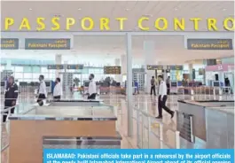  ?? AFP ?? ISLAMABAD: Pakistani officials take part in a rehearsal by the airport officials at the newly built Islamabad Internatio­nal Airport ahead of its official opening tomorrow on the outskirts of Islamabad. —