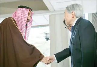  ??  ?? King Salman is received by Japan’s Emperor Akihito at the Imperial Palace where he was conferred the Daisy High Medal in Tokyo on Tuesday. (SPA)