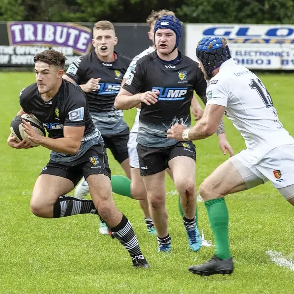  ??  ?? Brixham's Sam Thomas makes a breakthrou­gh during their big win against Newton Abbot at Astley Park on SaturdayAn­dy Uglow/Pyramid