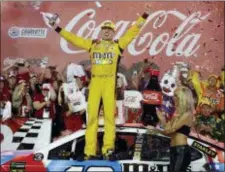  ?? CHUCK BURTON — THE ASSOCIATED PRESS ?? Kyle Busch celebrates after winning the NASCAR Cup Series auto race at Charlotte Motor Speedway in Charlotte, N.C., Sunday.