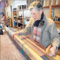  ??  ?? WEAVER Toni Boyd Broaddus works on a project at Tierra Wools’ shop in Los Ojos. Wool goods are for sale at the store.