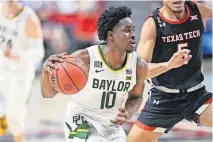  ??  ?? Baylor's Adam Flager (10) drives the ball during the second half of a Big 12 win over Texas Tech on Saturday. Baylor is 12-0 overall and 5-0 in the league. [AP PHOTO/JUSTIN REX]