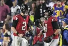  ?? MARK J. TERRILL — THE ASSOCIATED PRESS ?? Falcons quarterbac­k Matt Ryan, left, celebrates with backup quarterbac­k Matt Schaub after the throwing a touchdown pass Saturday against the Rams.