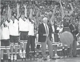  ?? ARIZONA DAILY STAR ?? The Arizona bench and coach Lute Olson react during the Wildcats’ NCAA title game against Kentucky in 1997. Arizona, a No. 4 seed, completed its improbable run with a win in overtime.