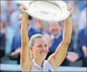  ?? AP ?? Germany's Angelique Kerber lifts the trophy after beating Serena Williams in women’s singles final at All England Club.