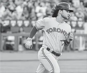  ?? ED ZURGA GETTY IMAGES ?? Toronto Blue Jays’ Bo Bichette hit the ground running in his major-league debut in Kansas City, reaching base on a single in his first at-bat at Kauffman Stadium on Monday night. The Blue Jays won the game, 7-3.