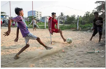  ?? — AFP ?? Winning ways: Kaung Khant Lin fighting for the ball during a football match in Yangon.