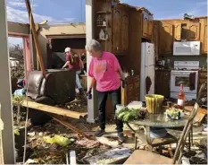  ?? AP PHOTO/JAY REEVES ?? Patti Herring sobs as she sorts through the remains of her home in Fultondale, Ala., on Tuesday after it was destroyed by a tornado.