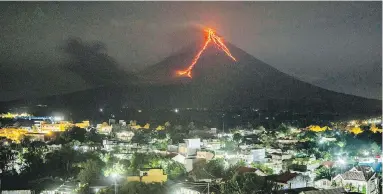  ??  ?? Lava flows down the slopes of the Mayon volcano in the Philippine­s in January. Scientists have long speculated that massive volcanic outbursts triggered a mass extinction of life on Earth 250 million years ago.