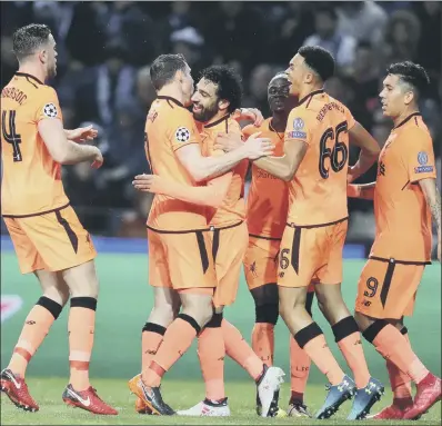  ?? PICTURE: AP PHOTO/LUIS VIEIRA ?? Liverpool’s Mohamed Salah celebrates with team-mates after scoring his side’s second goal in a 5-0 Champions League victory over FC Porto in the Dragao stadium in Portugal. Sadio Mane grabbed a hat-trick. Report: Page 22.