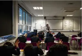  ?? MARY TURNER/NEW YORK TIMES ?? The Michaela secondary school in London is among those receiving a mix of praise and criticism for its methods.