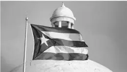  ?? RICARDO ARDUENGO/AP ?? The Puerto Rican flag flies in front of the Capitol in San Juan. The president and CEO of the Florida State Hispanic Chamber of Commerce says Congress must close a loophole that has allowed some companies to withhold informatio­n on bankruptcy proceeding­s.