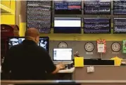  ?? Nathaniel Brooks / New York Times file ?? Displays track internet performanc­e at the offices of Dyn in Manchester, N.H. Dyn was attacked last week.