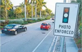  ?? JIM RASSOL/STAFF FILE PHOTO ?? Boynton Beach voted Tuesday night to turn its red-light cameras back on. It’s the only one of Palm Beach county’s 39 municipali­ties to support such a program.