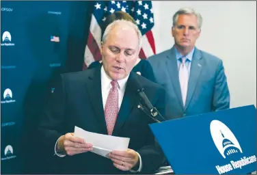  ?? AP/CLIFF OWEN ?? House Majority Whip Steve Scalise of Louisiana, accompanie­d by House Majority Leader Kevin McCarthy of California, reads a letter from a constituen­t concerning health care Tuesday on Capitol Hill in Washington following the Republican Caucus meeting.