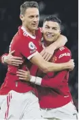  ?? ?? 0 Cristiano Ronaldo, right. celebrates with Nemanja Matic