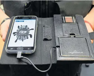  ??  ?? Scanner connected to a smartphone, which gives officers access to INK system