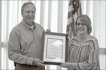  ??  ?? Contribute­d by Aimee Madden / City of Cedartown City manager Bill Fann presents City Clerk Carol Crawford with a copy of a proclamati­on passed celebratin­g Municipal Clerks Week and honoring her for her service to the city.