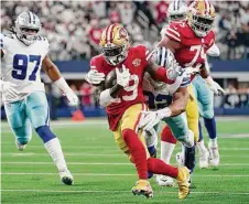  ?? Tony Gutierrez/Associated Press ?? San Francisco 49ers wide receiver Deebo Samuel (19) attempts to escape the grasp of Cowboys defensive end Dorance Armstrong during a wild-card playoff game last season.